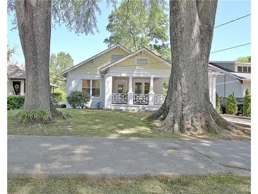 Charming home with a welcoming front porch framed by mature trees and a well-manicured lawn at 78 Atlanta Se Ave, Atlanta, GA 30315