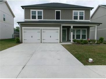 Charming two-story home with a two-car garage and a well-maintained front yard at 2197 Boxwood Cir, Conyers, GA 30094