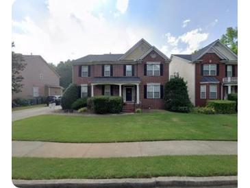 Traditional two-story home featuring a well-manicured lawn and mature landscaping at 2667 Hampton Park Dr, Marietta, GA 30062