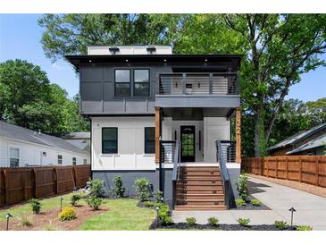 Contemporary two-story home with a balcony, landscaped yard, and inviting staircase at 32 Wadley Nw St, Atlanta, GA 30314