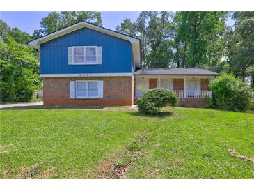 Charming two-story home with brick accents and lush green lawn at 4593 Bexley Way, Stone Mountain, GA 30083