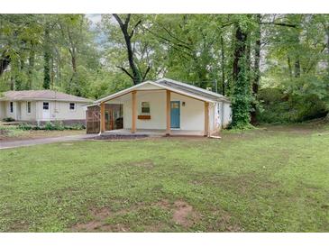 Charming single-story home with a covered porch and well-maintained lawn surrounded by mature trees at 2917 Reveille Se Cir, Atlanta, GA 30316