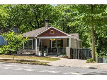 Charming home with a welcoming front porch, lush landscaping, and a well-maintained yard at 770 Ormewood Se Ave, Atlanta, GA 30312