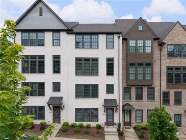 Beautiful townhouse with painted brick, dark windows, and mature landscaping at 6807 Prelude Dr, Atlanta, GA 30328