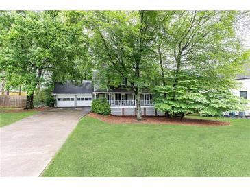 Charming home with well-maintained lawn, a two-car garage, and inviting front porch at 511 Pine Springs Se Trl, Marietta, GA 30067