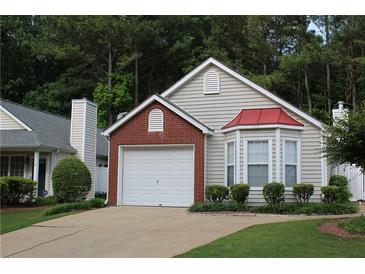 Charming home showcasing a well-manicured lawn, brick accents and a bay window at 1132 Britley Park Ln Ln, Woodstock, GA 30189