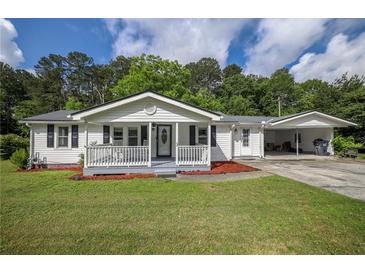 Charming single-story home featuring a covered porch and carport on a sunny day at 4067 Lenora Church Rd, Snellville, GA 30039