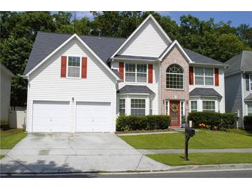 Charming two-story home with brick accents, a well-manicured lawn, and a two-car garage at 4450 Ivy Fork Dr, Loganville, GA 30052