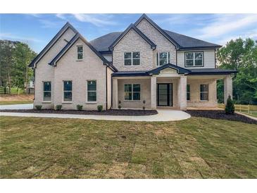 Charming two-story home featuring a stone and brick facade with black trim accents at 1465 Leach Dr, Lawrenceville, GA 30045