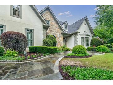 Charming home with well-manicured landscaping and stone walkway at 5318 Brooke Farm Dr, Dunwoody, GA 30338