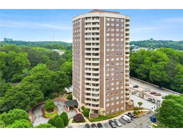 A mid-level exterior view of this brick highrise featuring well-maintained landscaping and convenient parking at 1501 Clairmont Rd # 1213, Decatur, GA 30033