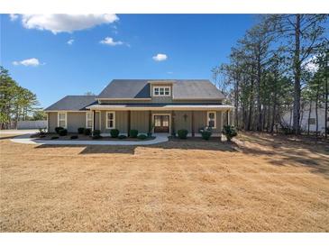 Charming one story home with a large front yard, covered porch, and mature trees at 8007 Wishaw Ct, Winston, GA 30187