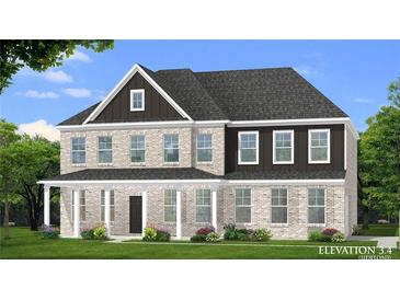 Charming two-story home featuring a light brick exterior and welcoming front porch at 178 Haverling Pass, Hampton, GA 30228