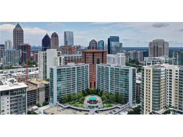 Stunning aerial view of luxury high-rise condominiums and the city skyline with rooftop pool and lush landscaping at 950 W Peachtree Nw St # 1613, Atlanta, GA 30309
