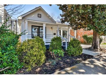 Charming bungalow featuring a well-manicured front yard and inviting front porch at 32 Howell Se St, Atlanta, GA 30312