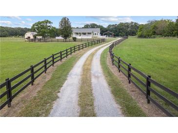 Picturesque home featuring a long driveway, fenced pasture, and an inviting country setting at 654 Euharlee Five Forks Rd, Kingston, GA 30145