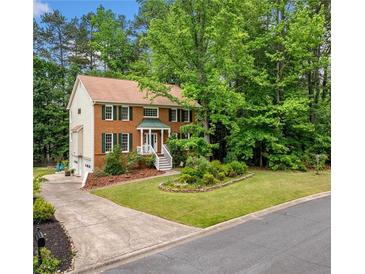 Charming two-story brick home with green shutters, landscaped yard, and inviting curb appeal at , Marietta, GA 30064