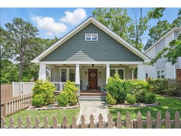 Charming home featuring a cozy front porch, a well-manicured lawn, and lovely landscaping at 2610 Cheney St, Atlanta, GA 30344