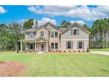 Beautiful two-story home featuring brick and siding and a well-manicured lawn at 600 Sidney Ct, Stockbridge, GA 30281