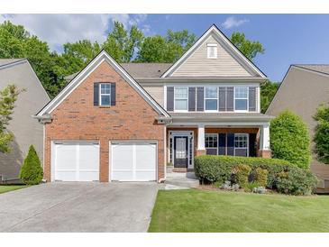 Charming two-story home featuring a brick facade, a two-car garage, and a well-manicured lawn at 2365 Valley Mill Dr, Buford, GA 30519