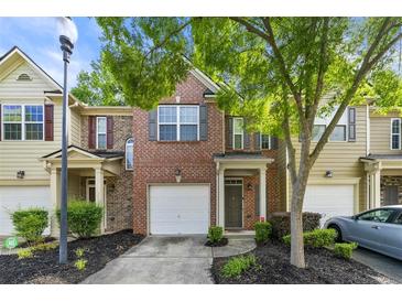 Charming townhouse with brick facade, attached garage, and well-maintained front yard landscaping at 3379 Thornbridge Dr, Powder Springs, GA 30127