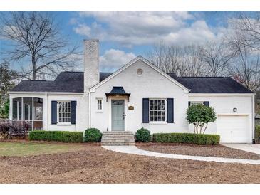Charming white brick home with a gray door, a well-manicured lawn, and black shutters at 332 Shadowmoor Dr, Decatur, GA 30030