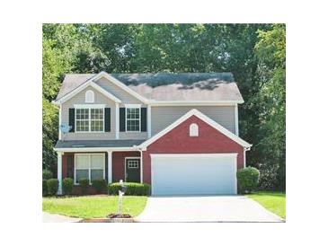 Charming two-story home with a well-manicured lawn and an attached two-car garage at 1000 Willow Crest Lndg, Austell, GA 30168