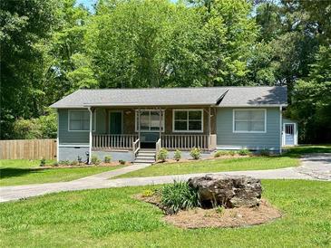 Charming one-story home with a rocking chair front porch and inviting curb appeal at 485 Angham Rd, Hiram, GA 30141