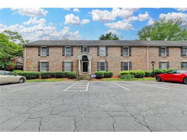 Charming brick condo building with ample parking and well-maintained landscaping at 6700 Roswell Rd # 22B, Atlanta, GA 30328