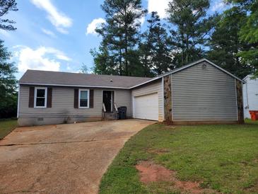 Cozy single-story home with a garage, stone accents, and a well-maintained lawn at 1094 Reynolds Ct, Morrow, GA 30260