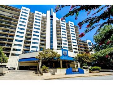 Modern high rise condo building with manicured landscaping and private balconies on a bright day at 1130 Piedmont Ne Ave # 709, Atlanta, GA 30309