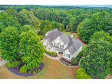 Stunning aerial view of a traditional home featuring lush landscaping and mature trees on a sprawling lot at 4809 Highland Point Dr, Auburn, GA 30011