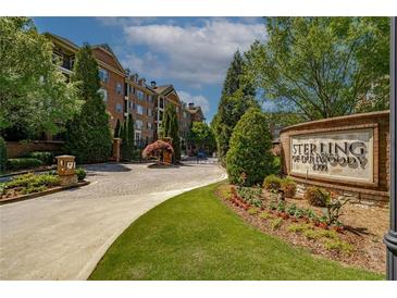 Elegant Sterling of Dunwoody community entrance with manicured landscaping and brick signage at 2300 Peachford Rd # 3411, Dunwoody, GA 30338