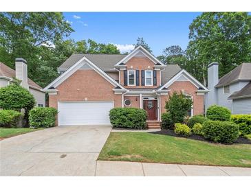 Charming two-story brick home with a well-manicured lawn and a two-car garage at 1010 Graystone Xing, Alpharetta, GA 30005