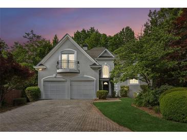 Charming two-story home with a balcony, two-car garage, and landscaped front yard at 4217 Wieuca Overlook Ne, Atlanta, GA 30342