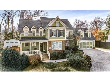 Charming two-story home boasts a manicured lawn, inviting front porch, and a convenient two-car garage at 192 Chicopee Dr, Marietta, GA 30060