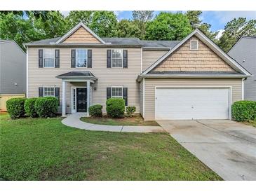 Charming two-story home with a well-maintained lawn and attached two-car garage at 6285 Polar Fox Ct, Riverdale, GA 30296