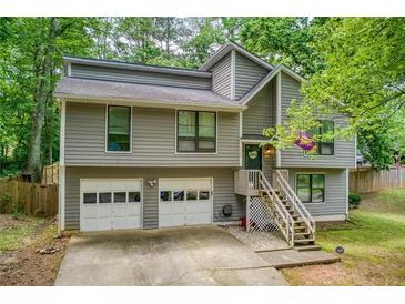 Charming two-story home with gray siding, a two-car garage, and a welcoming front porch at 1220 Wade Green Nw Cir, Acworth, GA 30102