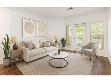Bright living room featuring a neutral palette, stylish furnishings, and a glass door leading to an outdoor space at 1850 Cotillion Dr # 4218, Atlanta, GA 30338