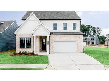Charming two-story home featuring a brick facade, a two-car garage, and a well-manicured front lawn at 602 Belshire Dr, Acworth, GA 30102