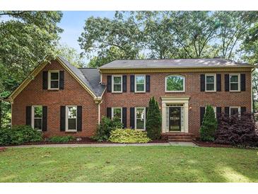 Charming two-story brick home featuring classic black shutters and a well-maintained lawn at 3267 Rememberance Trce, Lawrenceville, GA 30044
