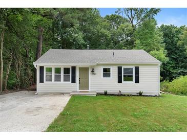 Charming bungalow-style home with a well-maintained lawn and a welcoming front entrance at 1980 Oakdale Se Ct, Smyrna, GA 30082