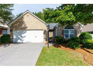 Charming brick home featuring a two-car garage and inviting front yard at 5251 Centennial Hill Nw Dr, Acworth, GA 30102