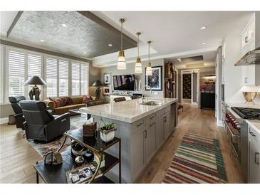 Bright, open-concept kitchen features a large island and stainless steel appliances at 58 Canton St # 410, Alpharetta, GA 30009