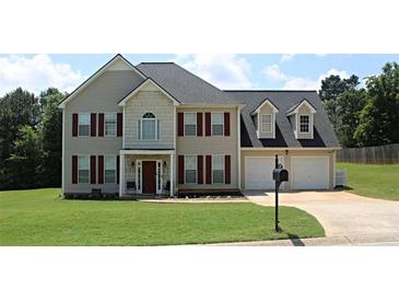 Charming two-story home featuring a well-manicured lawn and a two-car garage, perfect for suburban living at 80 Pine Valley Court, Hiram, GA 30141