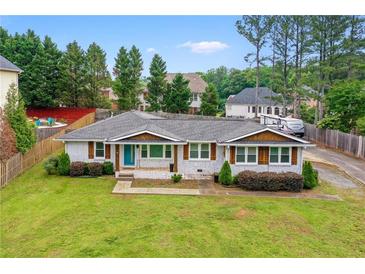 Charming, renovated ranch with a well-manicured lawn, brick exterior, and a new roof at 2221 Shallowford Rd, Marietta, GA 30066