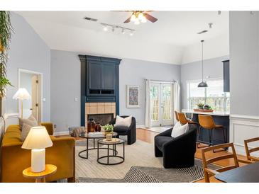 Bright living room featuring a fireplace, modern furnishings, and natural light from the french doors at 1026 Lester Se Ave, Atlanta, GA 30316