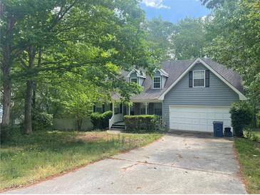Charming home with a traditional design, mature trees, and a two-car garage at 1075 Crystal Water Dr, Lawrenceville, GA 30045