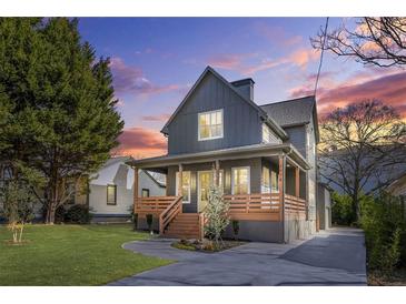 Charming two-story home features a welcoming front porch, manicured lawn, and a modern gray exterior at 3378 Bachelor St, Atlanta, GA 30344