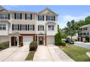A daytime exterior view of townhomes, each with a private garage and manicured landscaping at 6750 Blackstone Pl # 6, Mableton, GA 30126